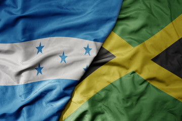 big waving realistic national colorful flag of honduras and national flag of jamaica . - obrazy, fototapety, plakaty