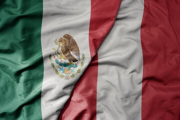 big waving realistic national colorful flag of mexico and national flag of peru .