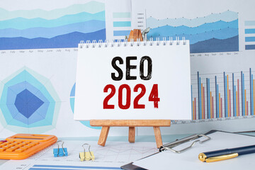On the magnifying glass are paper strips with the inscription - SEO 2024.