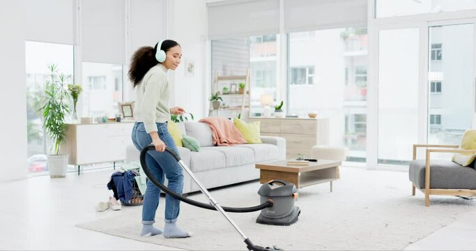 Music, cleaning and woman dance with vacuum, headphones and fun in her home on the weekend. Housekeeping, earphones and female dancing to radio, podcast and spring clean her house with dust machine
