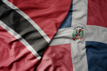 big waving realistic national colorful flag of trinidad and tobago and national flag of dominican republic .