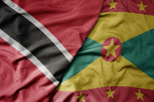 big waving realistic national colorful flag of trinidad and tobago and national flag of grenada . - Powered by Adobe
