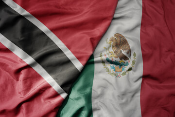 big waving realistic national colorful flag of trinidad and tobago and national flag of mexico .
