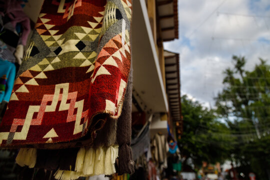 Macro closeup of a ruana hanging in a store in Raquira, Colombia