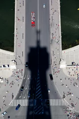 Cercles muraux Tower Bridge Shadow cast by the Eiffel Tower Paris falls onto the bridge with boats on the river Seine