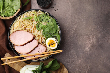 Delicious ramen with meat served on grey table, flat lay and space for text. Noodle soup