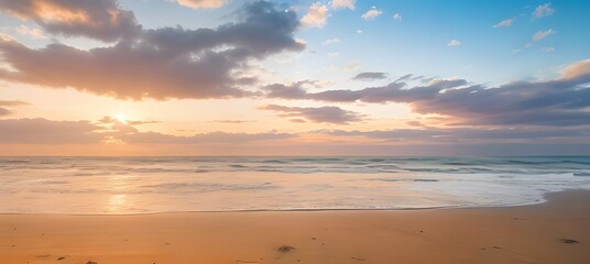 Obraz na płótnie Canvas 青空とオレンジ色の夕焼けがグラデーションするビーチの美しい風景