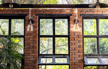 Modern workshop with big windows and indoor garden. Landscaped coworking space.