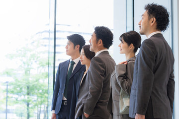Business people standing side by side, looking up to the future and hope.