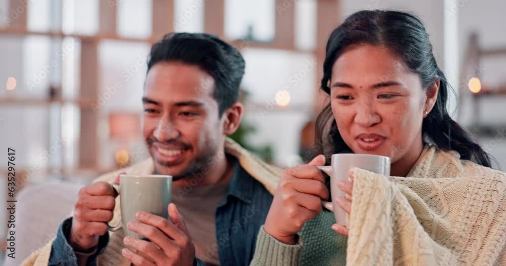 Wall mural Coffee, happy and couple with blanket on sofa for bonding, relax and cozy in living room with fire. Love, dating and man and woman with hot drink in mug in conversation, talking and speaking at home