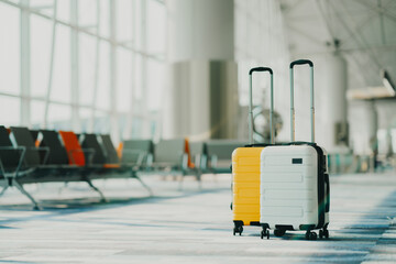 Two suitcases in an empty airport hall, traveler cases in the departure airport terminal waiting...