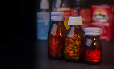 medicine bottle without label on black background