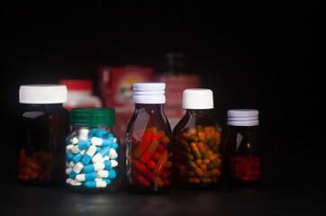 medicine bottle without label on black background