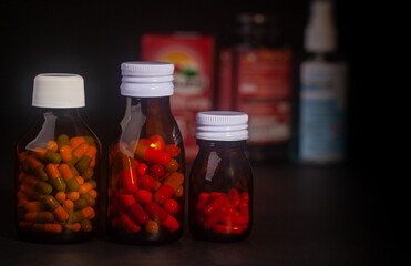 medicine bottle without label on black background