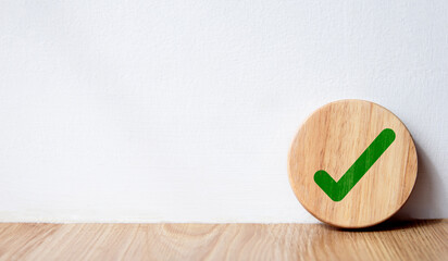 A circular plank with a green checkmark icon. checkmark, checkmark, tick icon, checkmark, green circle checkmark button, done. On white background. Banner. Copy space.