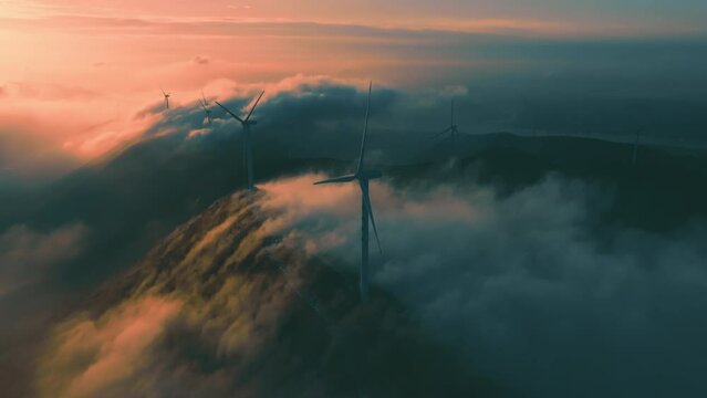 Morning drone shot of mountain top industrial wind power plant
