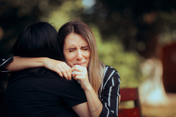 Sad Woman Crying on the Shoulder of her Best Friend. Unhappy girl feeling desperate in need of...