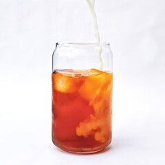 cold brew, cold coffee with mineral water and orange, pouring milk on a white background, refreshing drinks