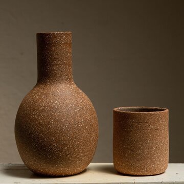 clay and ceramic vessel perched on a base, vase for drinking water on a neutral background mexico latin america