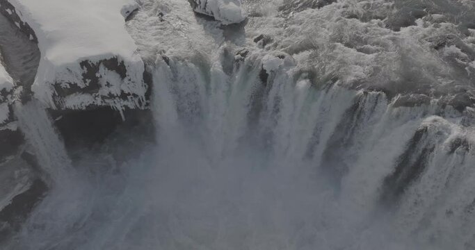 Aerial View of Cold Glacial Water Falling into Canyon on Sunny Winter Day, Iceland. Go&eth;afoss Waterfall