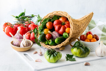 A cornucopia filled with freshly harvested summer produce.