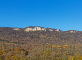 A road and a mountain landscape, an autumn plot in a journey through the wild places of nature.