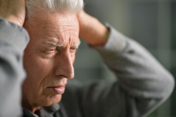 Portrait of stressed businessman touching his head