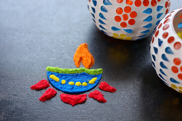 Diwali celebration Indian festival of lights Diya oil lamp lantern. Colors Rangoli decoration...