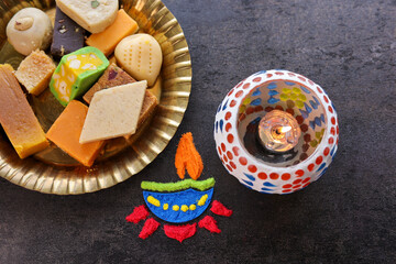 Diwali celebration Indian festival of lights Diya oil lamp lantern. Colors Rangoli decoration colorful flowers flowerbed copy space. Greetings Deepavali Hindu festival North India Mumbai Delhi India.