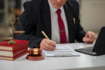 Male lawyer businessman sitting in the office doing legal work.