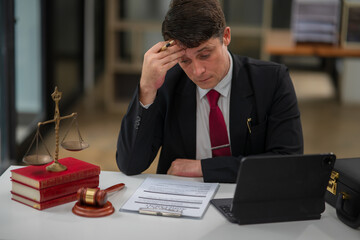 Male lawyer businessman sitting in the office doing legal work.