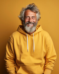 Obraz premium Handome senior man smiling wearing yellow sweatshirt isolated , Created with Generative Ai Technology