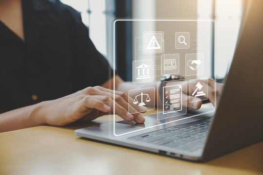 Legal business concept. Labor law, Lawyer, Online legal advice, Hand of human with legal services icon on laptop screen.