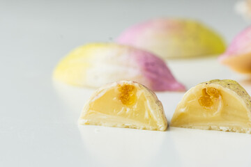 Set of homemade chocolate bonbons slice. Assortment of hand painted candies. Candy cut in a half. Mockup with a copy space. Macro shot of  chocolatier products on white background