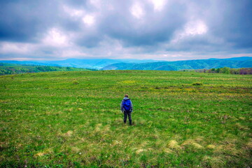 Fototapeta premium mature tourist travels in the ural mountains in early spring