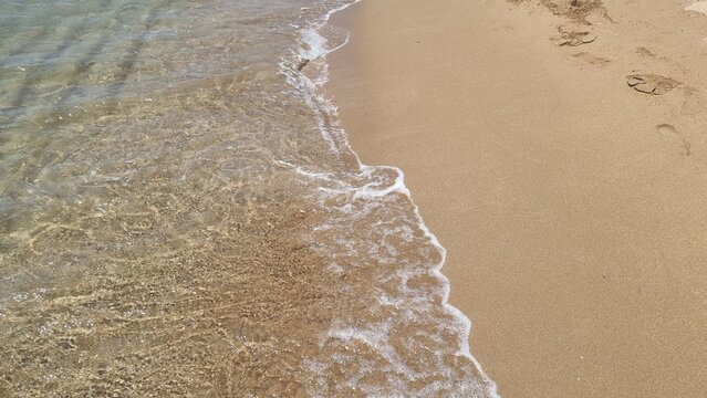 corfu keryra beach issos in summer sunny day ubrellas water sports windsurfing and clear colors for background greece