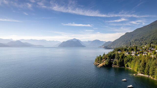 Howe Sound at sunset from high above Lions Bay, British Columbia, Canada. Aerial image of the wide open ocean with islands in the background.
