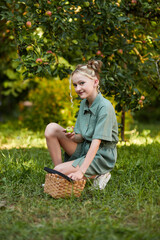 Beautiful girl against the backdrop of an autumn garden with apples
