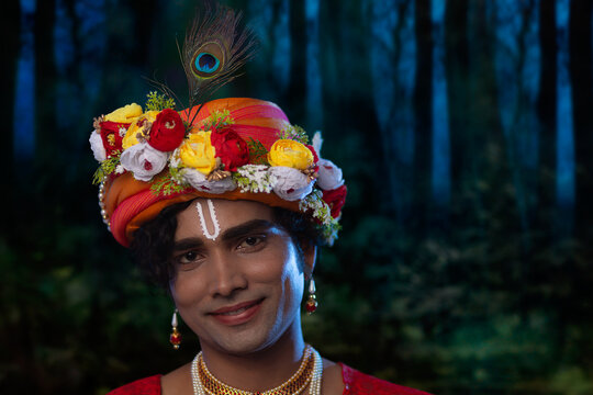 Close-up portrait of young man dressed up as Lord Krishna on the occasion of Janmashtami