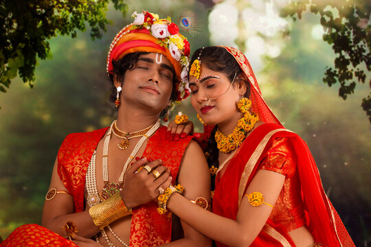 Young man and woman dressed up as Radha and Krishna and romancing on the occasion of Janmashtami