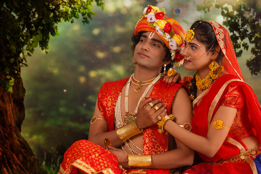 Young man and woman dressed up as Radha and Krishna and romancing on the occasion of Janmashtami