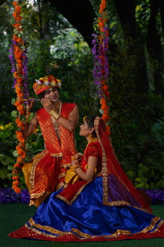 Young man and woman dressed up as Radha and Krishna and performing on the occasion of Janmashtami