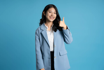 image of young businesswoman posing on blue background