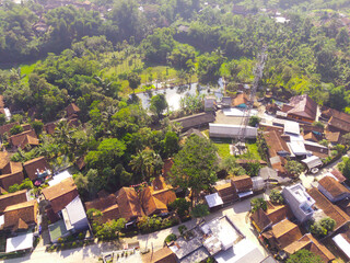 Fototapeta premium Bird's-Eye Cityscape with Dense Residential Area and Greenery. Aerial Drone Shot. Aerial view of a Residential district on the slopes of Mount Pangradinan. Bandung - Indonesia