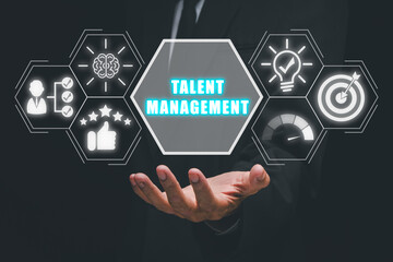 Talent management concept, Businessman hand holding talent management icon on virtual screen.