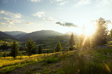 Settlement on a hill against the backdrop of a beautiful sunset © Cavan