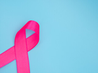 teal awareness ribbon over blue background. concept for support to fight cervical cancer.