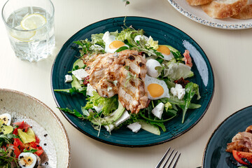 warm salad with grilled chicken and egg . restaurant menu