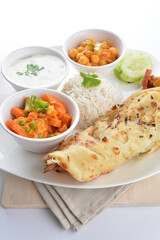 indian baked roti prata canai 2 pieces with spicy chilli curry chicken gravy soup sauce in plate on white background asian halal food cuisine menu for cafe design