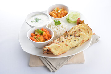 Indian traditional baked roti prata canai with curry vegetables, yogurt sauce, pea bean and steamed white rice  in plate on white background asian halal food vegan cuisine menu for cafe design
